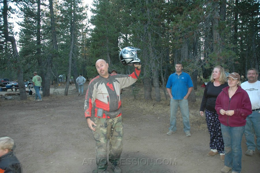 127. Ken begins the annual tradition of passing around Terry's helmet..jpg